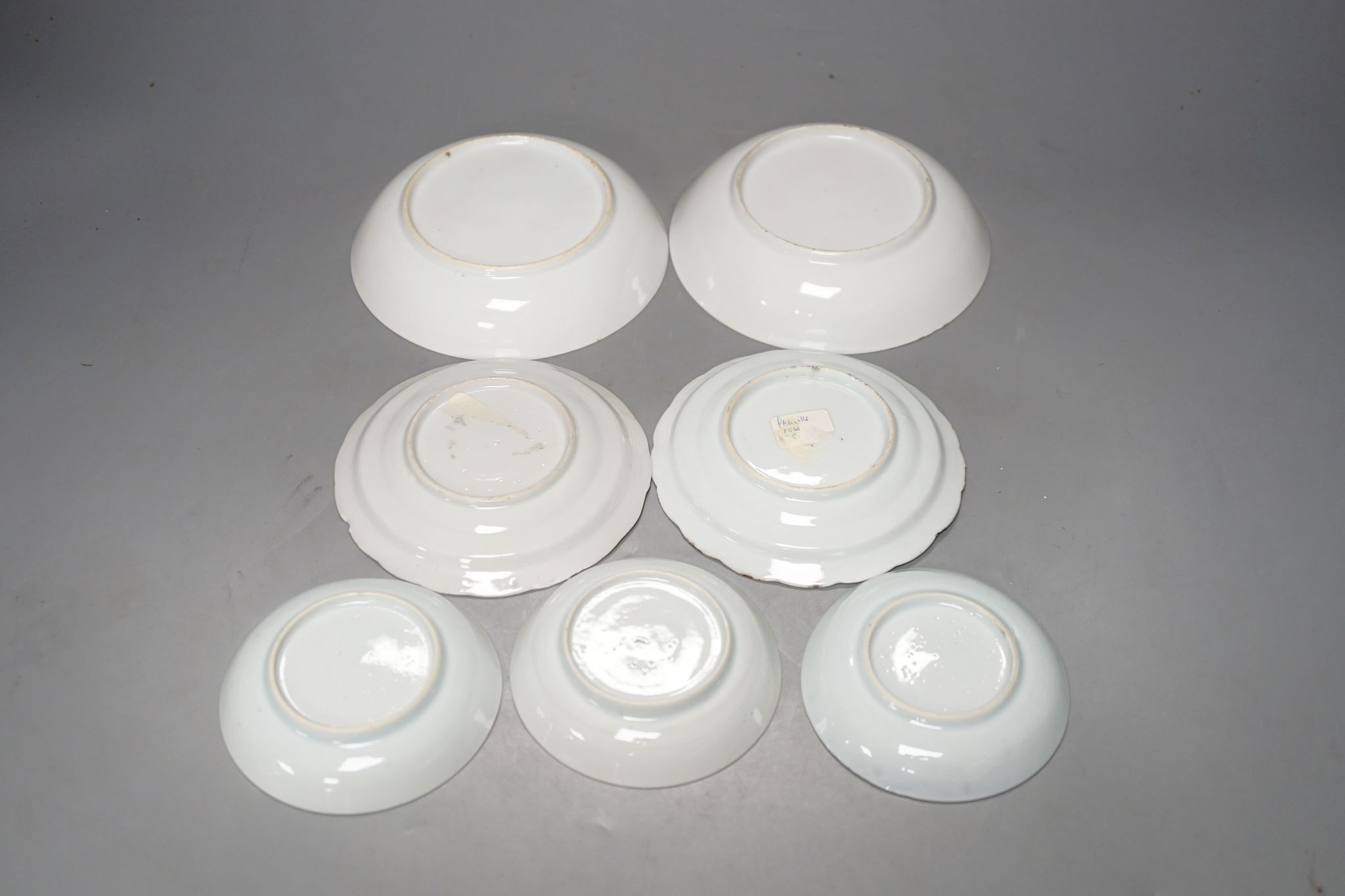 Seven 18th century Chinese saucer dishes, largest 14 cms diameter.
